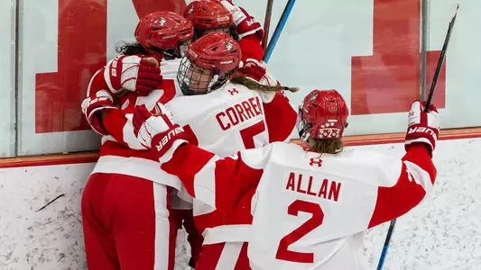 The women's ice hockey team celebrates a goal