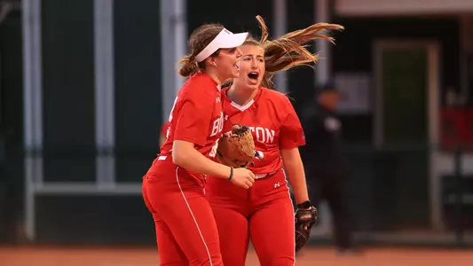 Ali DuBois and Caitlin Coker celebrate near the pitcher's circle following a 2-0 win against Stetson.