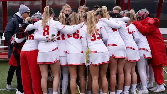 Women's lacrosse in a team huddle