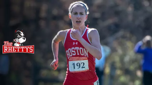 The Rhettys logo is located to the left of an action photo of Abigail Gugel running during the Patriot League Cross Country Championship