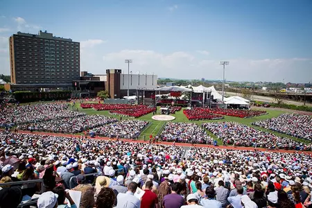 A wide angle photo from the top of the stands overlooking the BU commencement gathering at Nickerson Field.