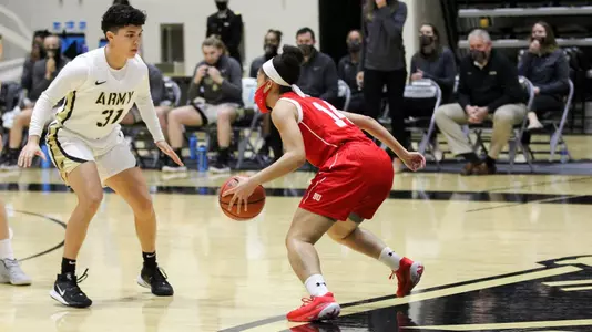 Sydney Johnson dribbling towards an Army defender