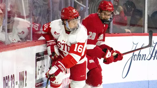 Robert Mastrosimone against the boards next to a Sacred Heart defender