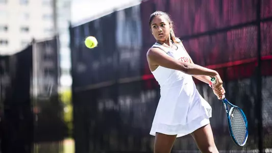 Sydney Sharma gets ready for a double-handed swing as the tennis ball approaches above her waist.