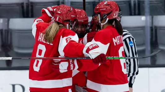 The women's ice hockey team celebrates a goal