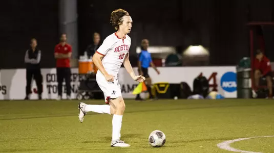 Colin Innes drives the soccer ball up the field.