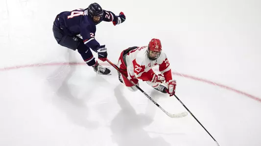 Domenick Fensore is skating while being chased by a UConn defender