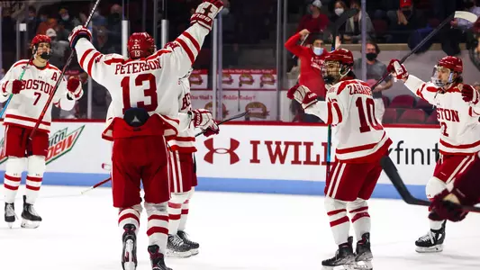 The men's ice hockey team celebrates a goal