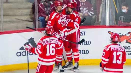 The men's ice hockey team celebrates a goal