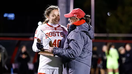 Jenna Oldham receives her Patriot League Defensive Player of the Year award alongside Head Coach Nancy Feldman.