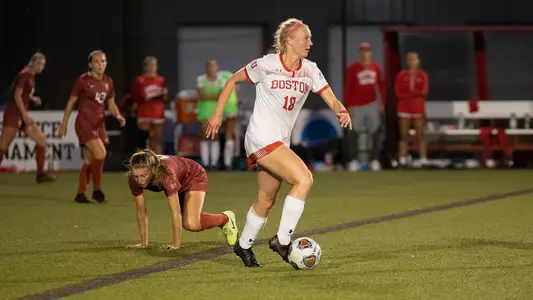 Julianna Stureman races past a Harvard defender.