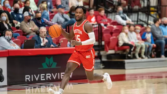 Jonas Harper brings the ball up the court.