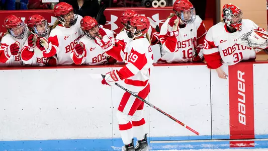 The women's ice hockey team celebrates a goal