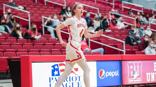 Liz Shean observes the play unfolding from the wing while the crowd looks on.