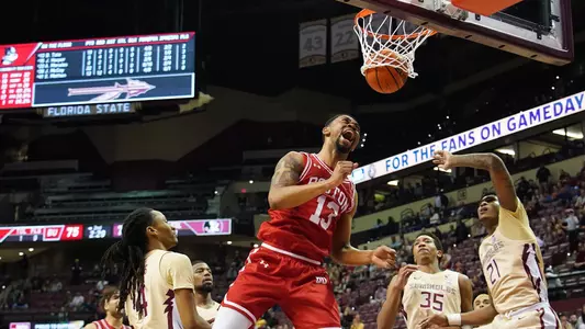 Daman Tate celebrates a slam dunk mid air at Florida State.