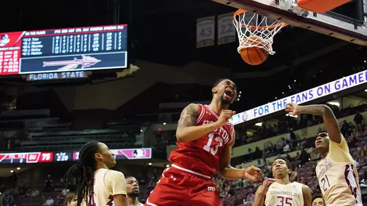 Daman Tate celebrates a slam dunk mid air at Florida State.