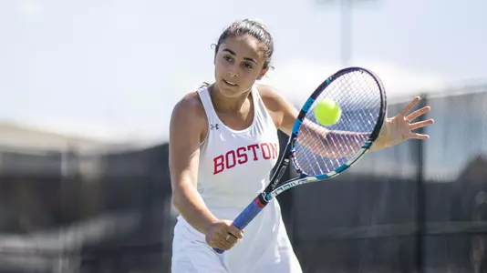 Shelly Yaloz hits a backhand volley with the tennis ball approaching.