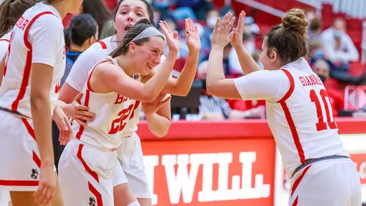 Maggie Pina and Alex Giannaros celebrate after Pina hits a three-pointer while drawing a foul.
