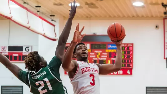 Malcolm Chimezie goes up for a short jumper shot with a Binghamton defender stretching out an arm for the block attempt.