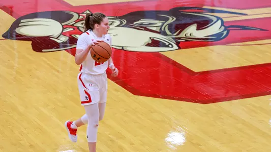 Emily Esposito dribbles the ball past halfcourt against UNH.