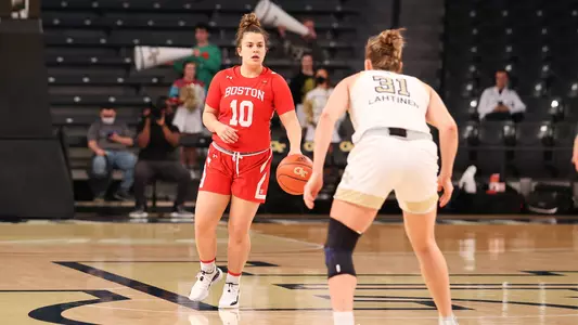 Alex Giannaros dribbles up the court while a Georgia Tech defender looks on.