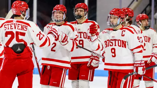 The men's hockey team celebrates a win