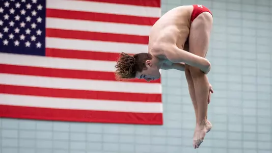 Lyde De Hooghe is in the tucked position during his dive at the BU competition pool.