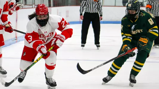 Tamara Giaquinto skates with the puck while being pursued by a Vermont player