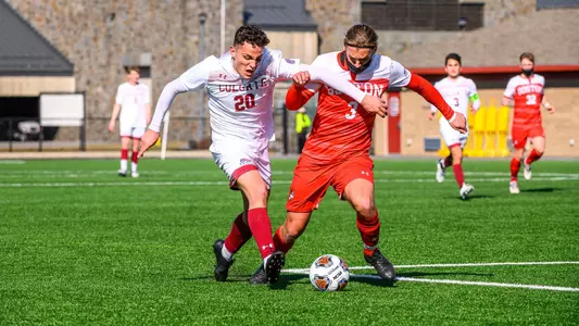 Gianluca Arlotti battles with a Colgate player for the soccer ball while running down the field.