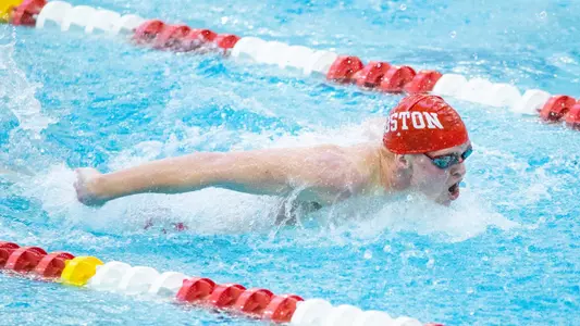 Boston University men's swimmer competing