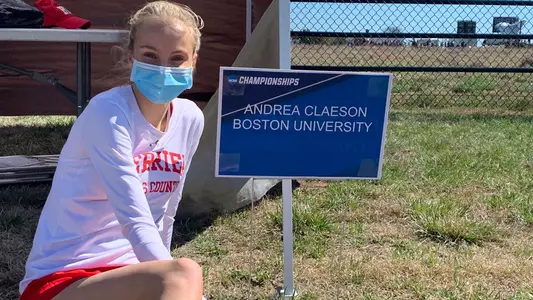 Andrea Claeson sitting next to an NCAA Championships sign that says "Andrea Claeson Boston University"