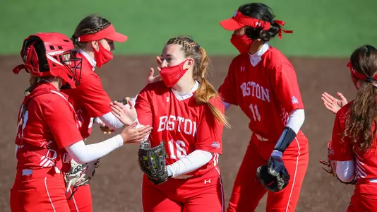 Ali DuBois goes through her high-five routine in the circle with the infield before starting the inning.