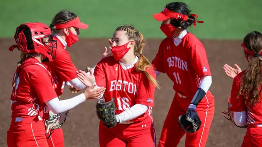 Ali DuBois goes through her high-five routine in the circle with the infield before starting the inning.