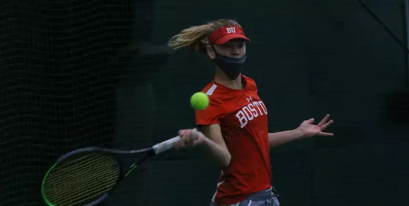 Katya Martens is pulling back the racquet on the forehand side with the tennis ball coming at her.