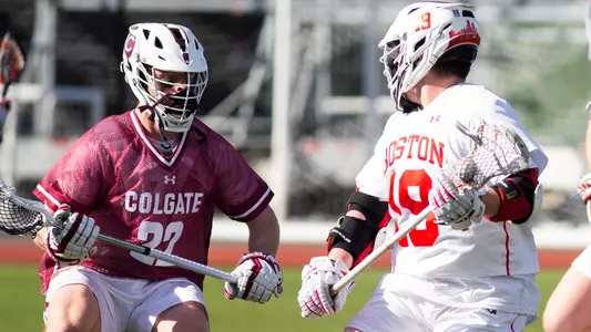 Timmy Ley cradles the ball while facing a Colgate defender