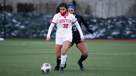 Geovanna Pereira with the ball at her feet as an Army defense is guarding her