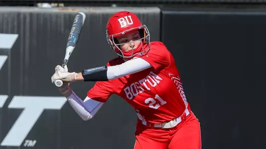 Kayla Roncin is swinging at the plate as a pitch approaches.