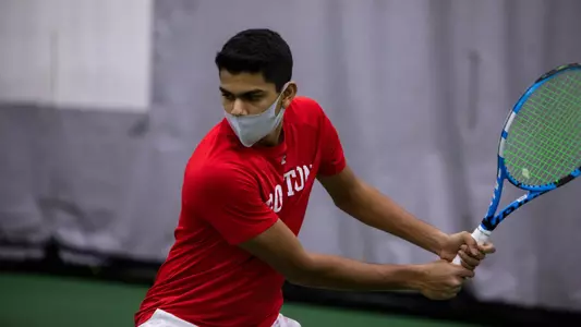 Tanisq Mallpani is positioned to use his backhand on an incoming tennis ball.