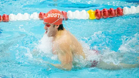 BU men's swimmer competing in the breast stroke