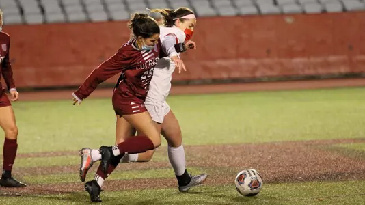 Ashley Buck and Colgate defender battling for a 50/50 ball