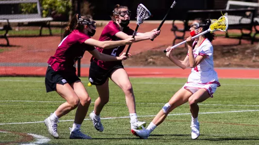 Emily Vervlied backing up against two defenders