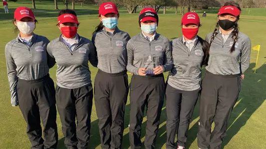 The Boston University women's golf team poses with the trophy after winning the FDU Invitational