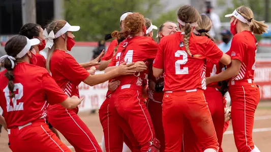 The softball team celebrating after recording the final out of the PL championship