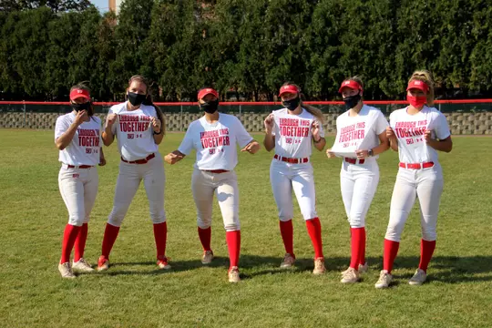 Members of the softball team wearing Through This Together shirts