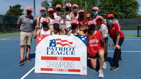 The women's tennis team posing with the Patriot League championship trophy