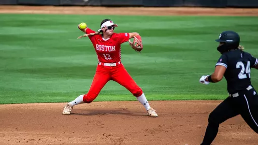 Audrey Sellers throws the ball to first from second while wearing shades.
