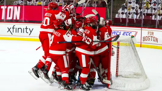The women's ice hockey team celebrates a victory at Boston College