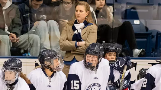 Kerstin Matthews coaching on the St. Anselm hockey bench