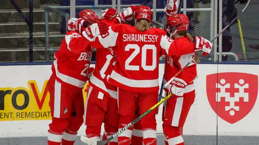 The women's ice hockey team celebrates a goal