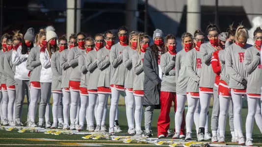 The women's lacrosse team lining up for the National Anthem